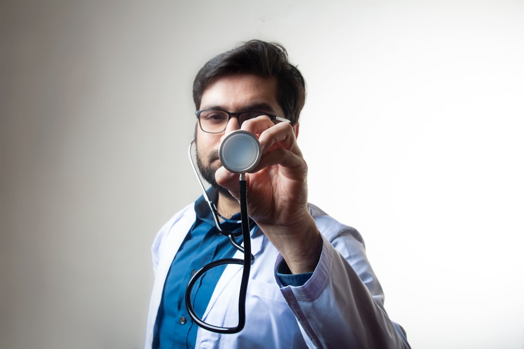 Business professional in a modern office carefully scrutinizes a real estate contract with a magnifying glass, symbolizing...