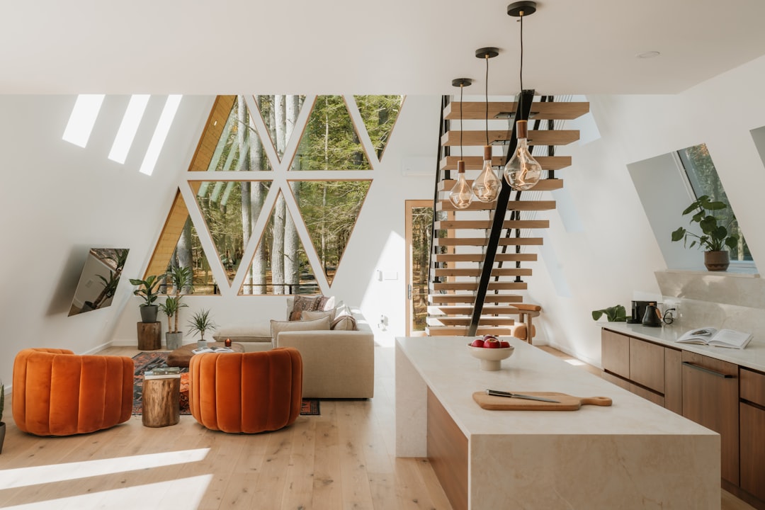 A client and a realtor have a serious, professional discussion inside a bright, minimalist home, highlighting the importance of asking the right questions.
