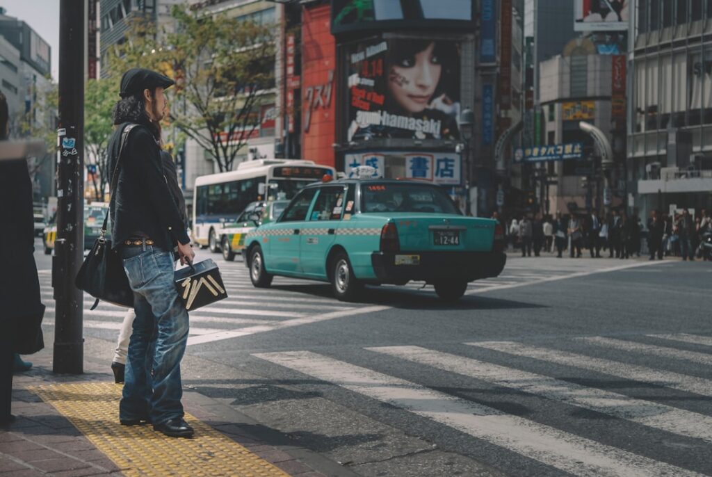Person stands on a city street, looking at a map on their smartphone with a frustrated or confused expression, representin...