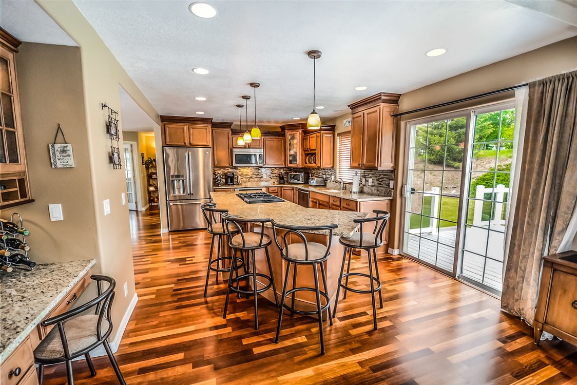 A set of house keys resting on a clean, modern wooden table in a brightly lit room, symbolizing a successful and financially smart real estate transaction.