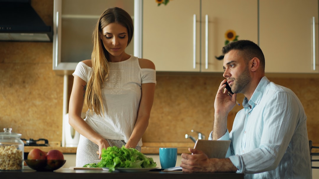 Sharply dressed professional stands inside a modern home, carefully reviewing a clipboard, symbolizing the due diligence a...