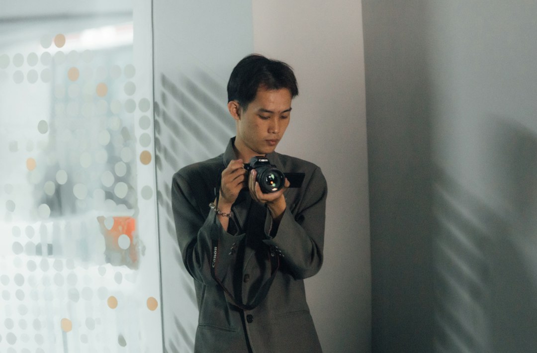 A professional looking thoughtfully at a screen with a clean, bright digital overlay of data points and connections, illustrating AI's role in business analytics and strategy.