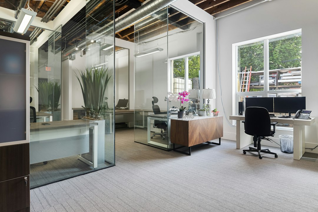 A sleek, minimalist office interior where a sophisticated robotic arm is positioned, representing the integration of AI and automation to boost operational efficiency.