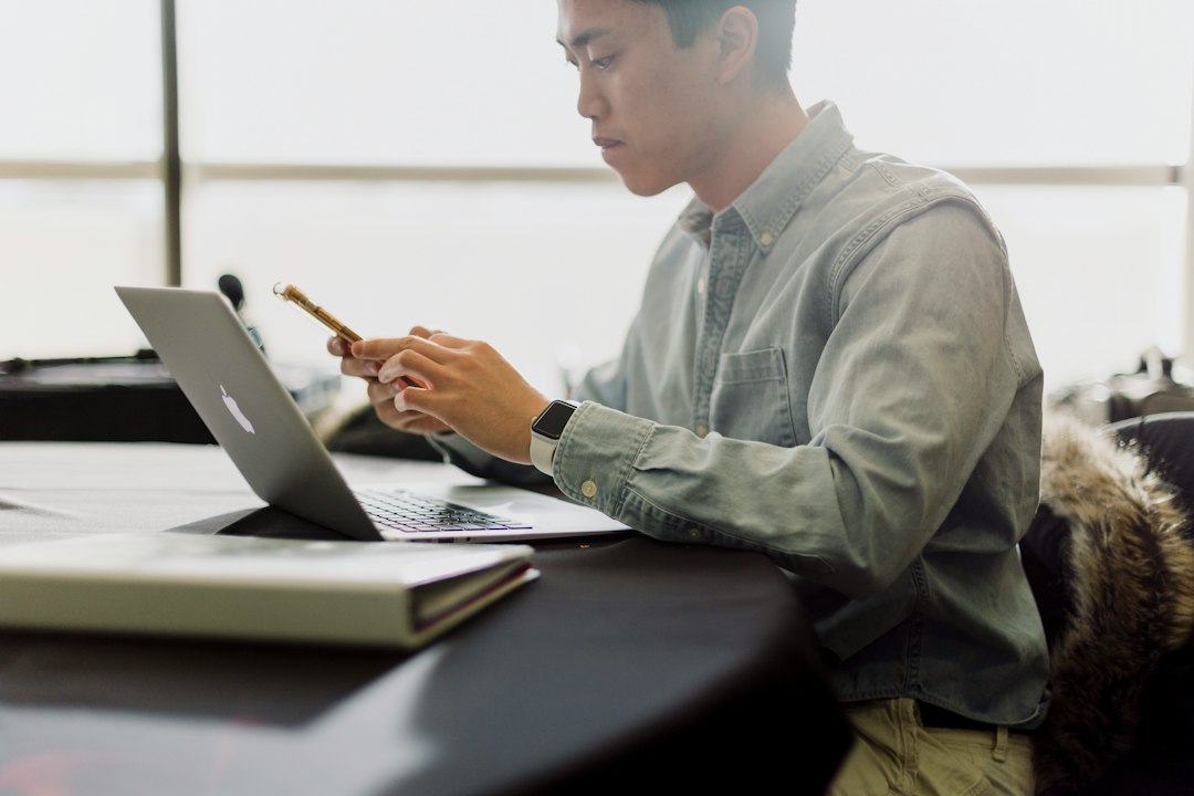 An architect carefully examines blueprints spread across a clean, modern desk, representing the importance of systems and long-term vision in business.